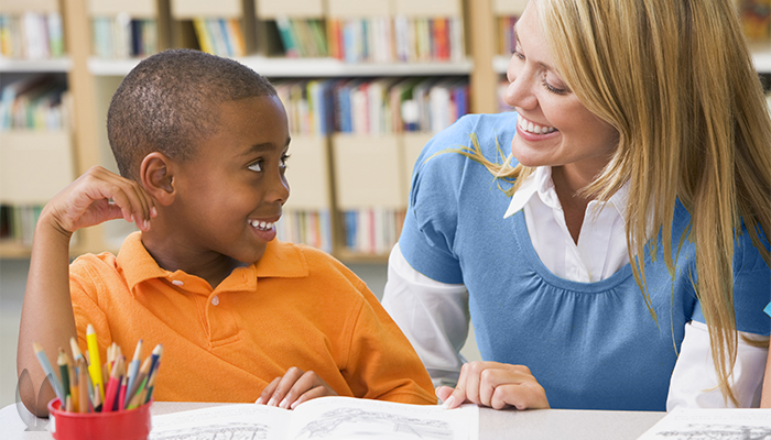 A teacher is helping a student with his work.