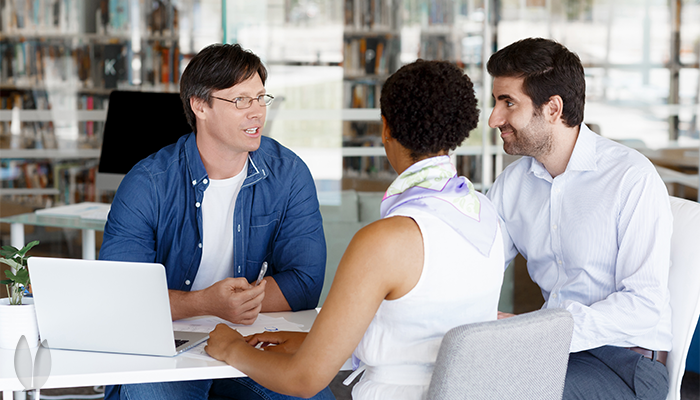 A couple is meeting with a business consultant for business advice.