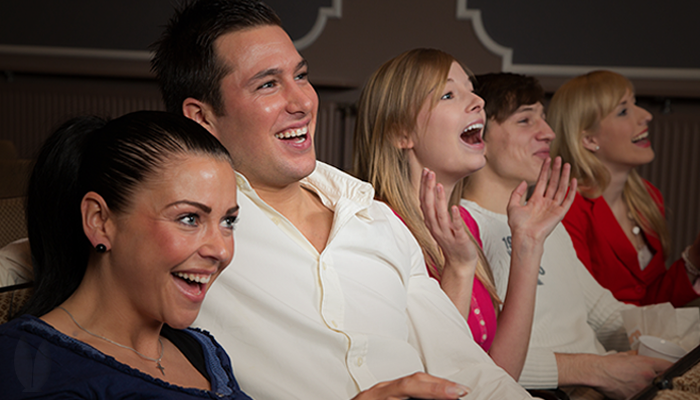 A group of friends laughing at a play.