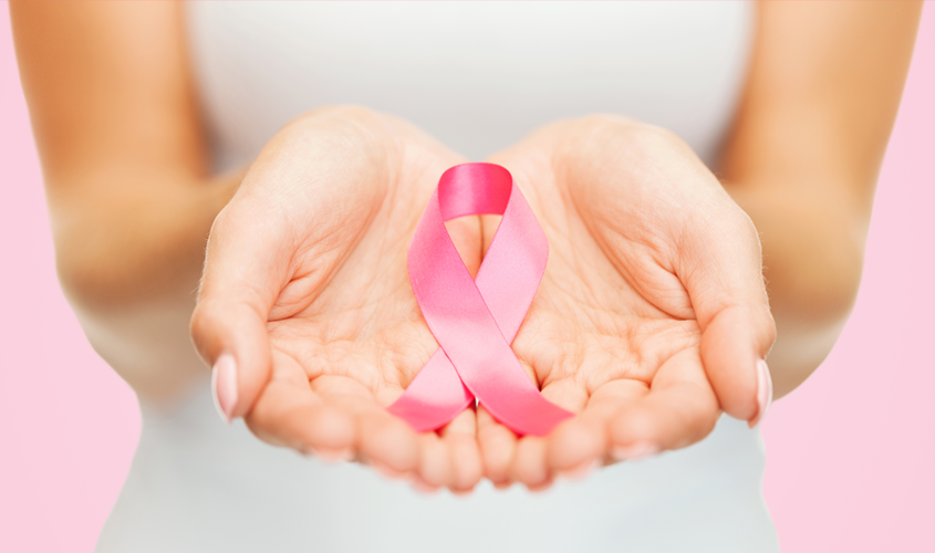 A woman is holding a Breast Cancer Awareness thread.