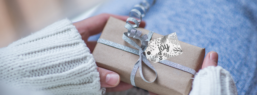 A girl is opening a present.