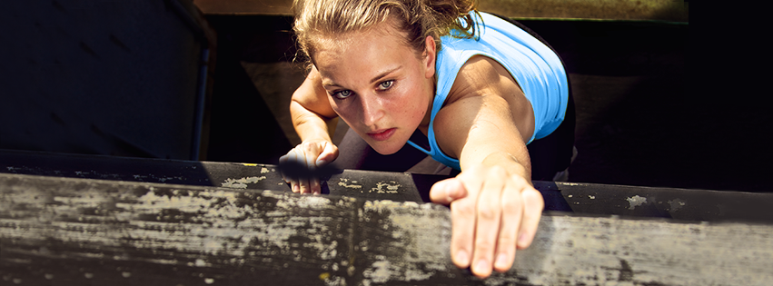 A woman is climbing up shelves.