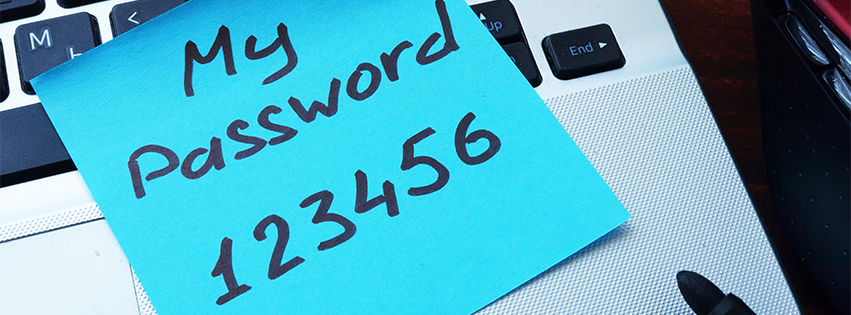 A basic password is written on a blue sticky note.