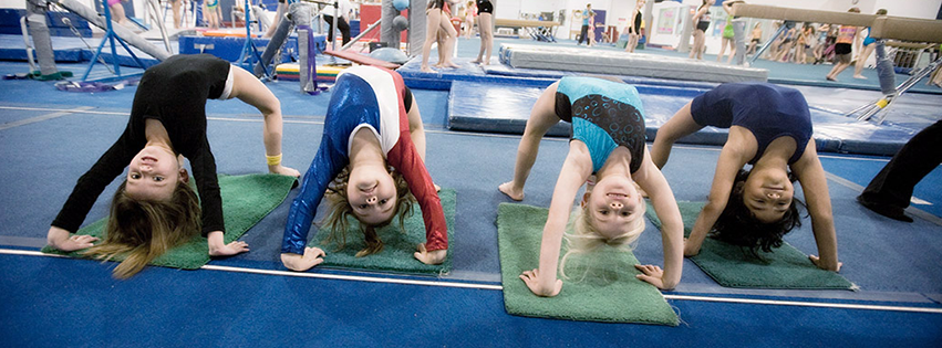 Young girl gymnasts doing a bridge.