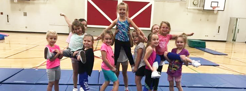 Premier Academy gymnastics students are showing off the poses they learned in class.