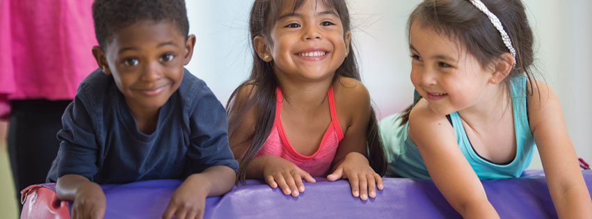 Young boy and girls enjoying a co-ed gymnastics class