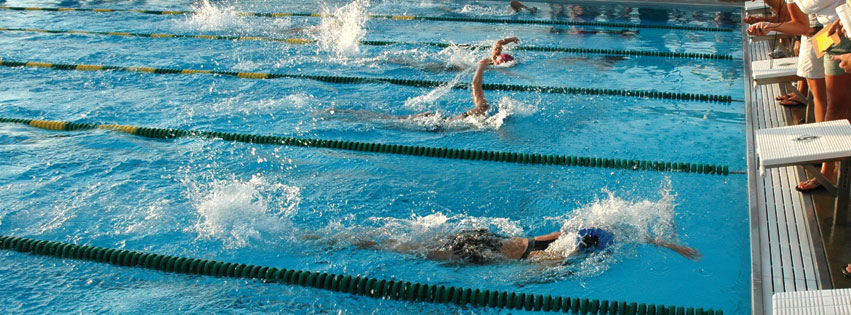 Kids in a swimming in pool and how they prepare for a competition