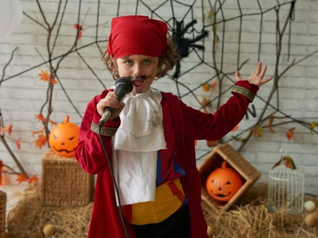 young boy in pirate costume with microphone