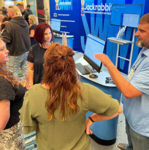 Jackrabbit staff and clients at trade shows looking at software