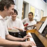 Students play music together in a classroom