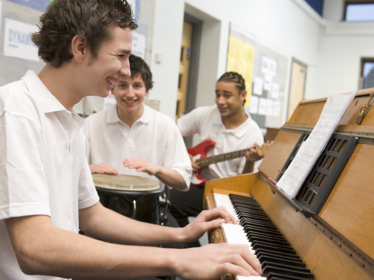 Students play music together in a classroom