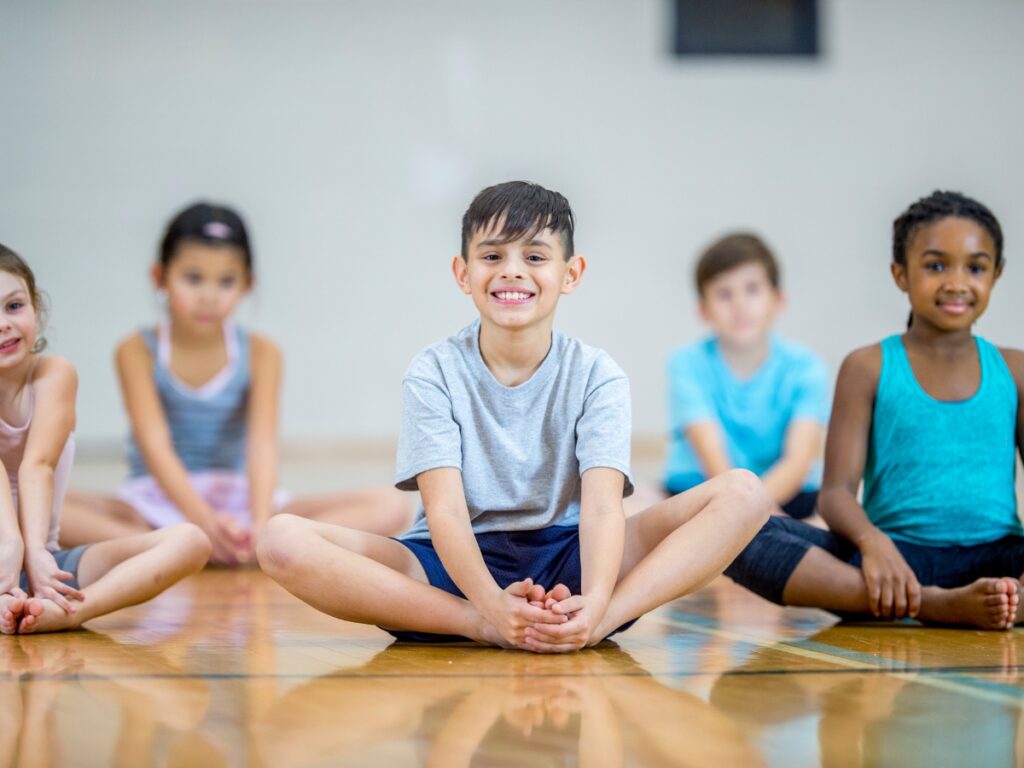 Students Do Yoga in Gym